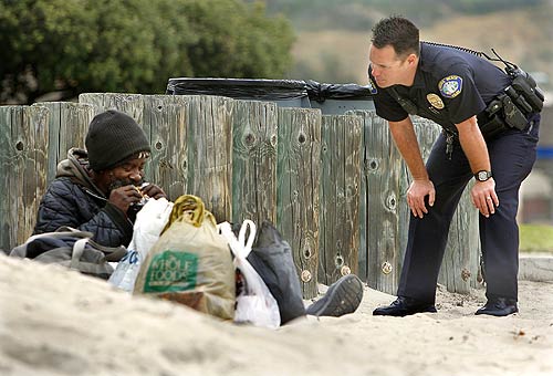 homeless-on-beach-with-cop.jpg